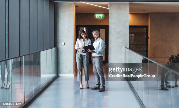 business people walking and talk to each other in front of modern office - business woman man with mobile bildbanksfoton och bilder