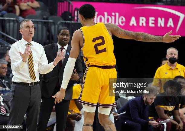 Head coach Bobby Hurley and assistant coach Jermaine Kimbrough of the Arizona State Sun Devils talk with Jalen Graham as the team takes on the...
