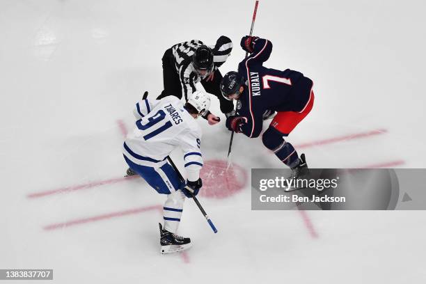 John Tavares of the Toronto Maple Leafs and Sean Kuraly of the Columbus Blue Jackets line up for a face-off during the first period of a game at...