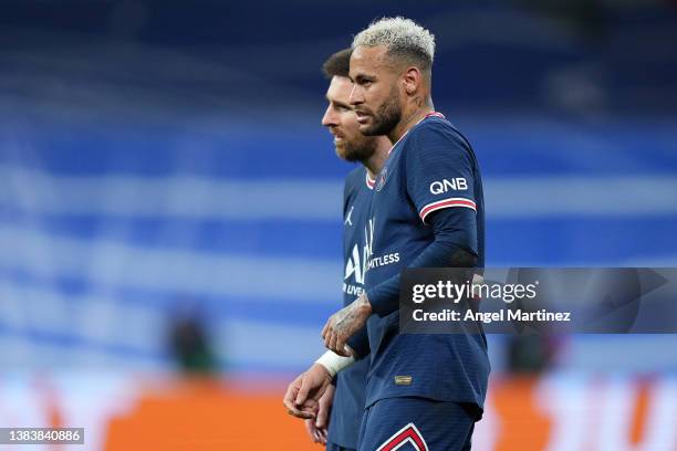 Lionel Messi and Neymar Jr of Paris Saint-Germain look on during the UEFA Champions League Round Of Sixteen Leg Two match between Real Madrid and...