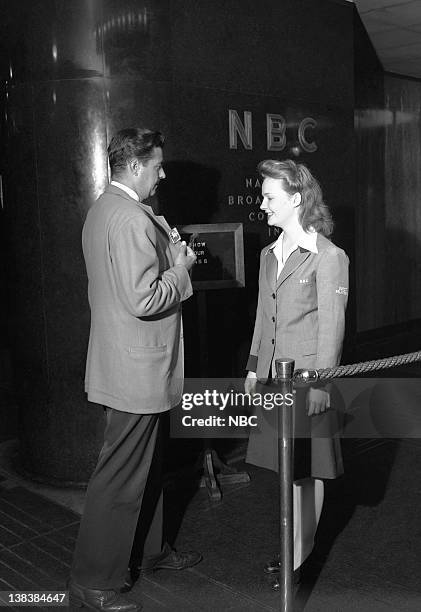 Pictured: NBC Girl Page Martha Maxwell, a replacement for the boy pages who have gone into service, checking IDs at NBC Radio City Studios on July...