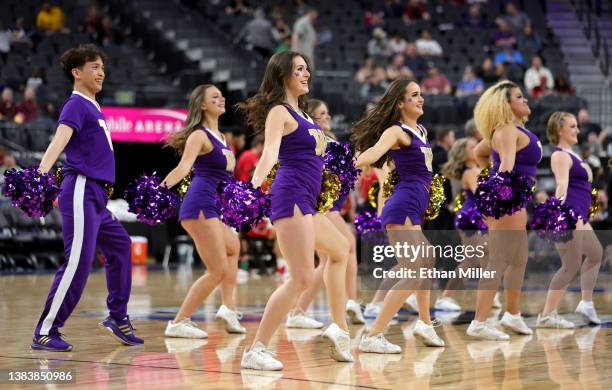 Washington Huskies cheerleaders perform during the team's game against the Utah Utes in the first round of the Pac-12 Conference basketball...