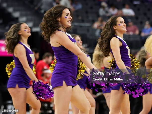 Washington Huskies cheerleaders perform during the team's game against the Utah Utes in the first round of the Pac-12 Conference basketball...