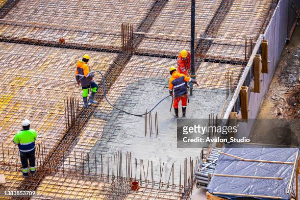 concrete pouring on the construction site. - strong foundations stock pictures, royalty-free photos & images