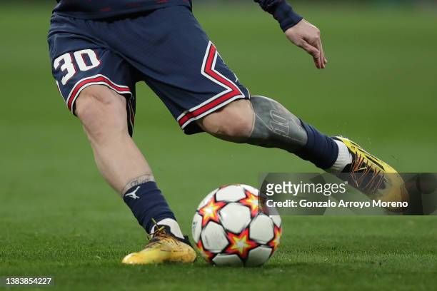 Lionel Messi of Paris Saint-Germain strikes the ball as he warms up before the UEFA Champions League Round Of Sixteen Leg Two match between Real...