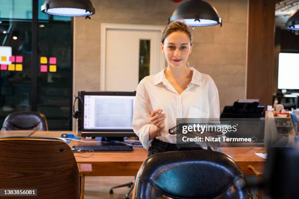 supporting gender equality in the tech industry. portrait of a female software developer holding a digital tablet in a tech business office.she specializes in software development and project management. - software as a service stock pictures, royalty-free photos & images