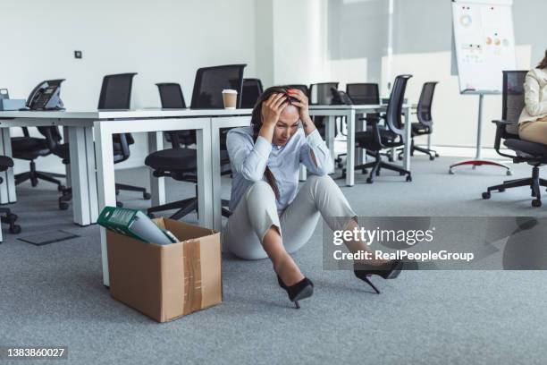 woman office worker is unhappy with being fired from a company packing things into cardboard boxes. - i quit stock pictures, royalty-free photos & images