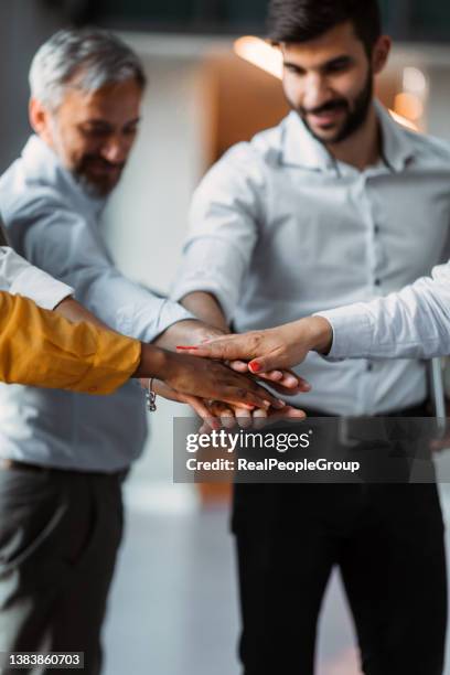 close up mixed race business people putting hands together, support and unity concept. diverse colleagues joining in team building activity, staff training concept, start working together, teamwork. - team building stock pictures, royalty-free photos & images