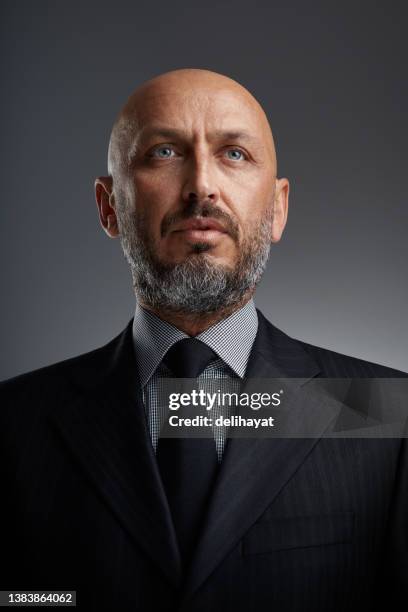 studio portrait of a middle eastern middle-aged bearded businessman posing against a dark background - shirt and tie close up stock pictures, royalty-free photos & images