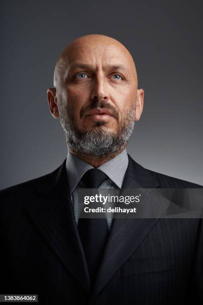 studio portrait of a middle eastern middle-aged bearded businessman posing against a dark background - handsome middle eastern men bildbanksfoton och bilder
