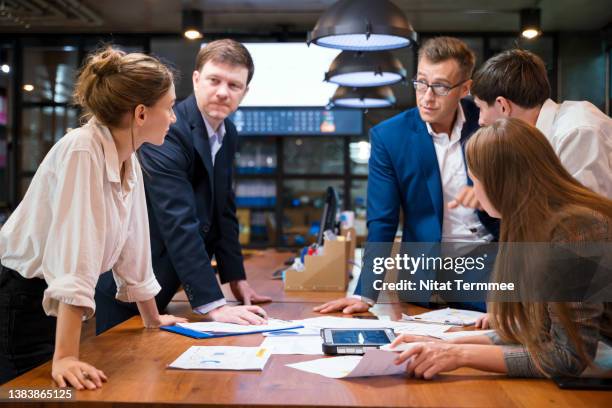 build effective team collaboration in the workplace. business development team during a meeting and discussion about improve rebranding by focusing on the right target market in a business office. - força operacional imagens e fotografias de stock