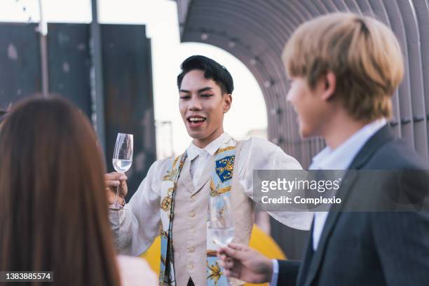 young business people toasting with each other and smiling while standing on rooftops - champagne rooftop stock pictures, royalty-free photos & images