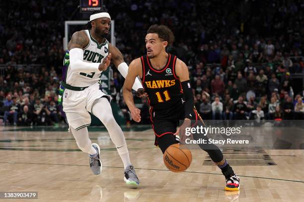 Trae Young of the Atlanta Hawks drives around Wesley Matthews of the Milwaukee Bucks during a game at Fiserv Forum on March 09, 2022 in Milwaukee,...