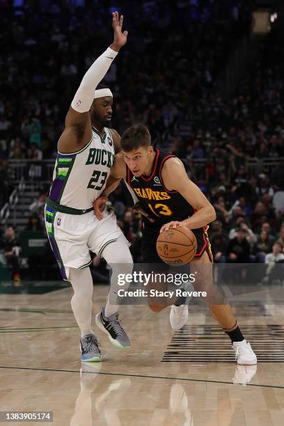 Bogdan Bogdanovic of the Atlanta Hawks drives around Wesley Matthews of the Milwaukee Bucks during a game at Fiserv Forum on March 09, 2022 in...