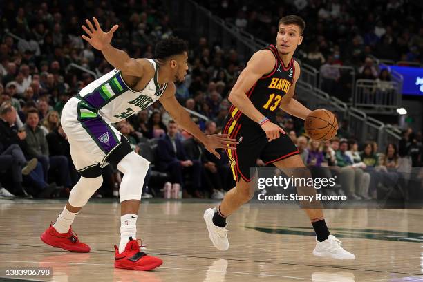 Bogdan Bogdanovic of the Atlanta Hawks is defended by Giannis Antetokounmpo of the Milwaukee Bucks during a game at Fiserv Forum on March 09, 2022 in...