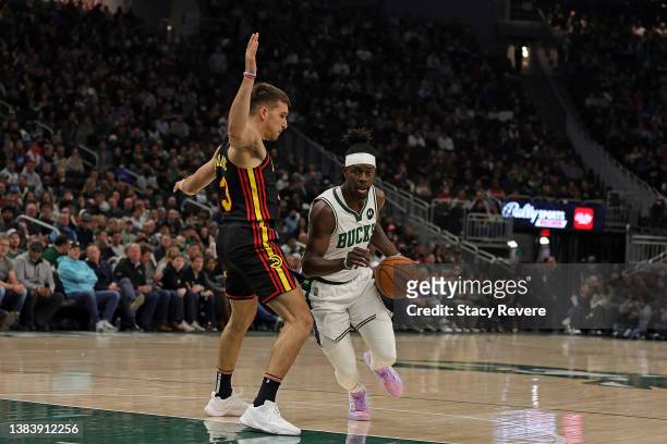 Jrue Holiday of the Milwaukee Bucks is defended by Bogdan Bogdanovic of the Atlanta Hawks during a game at Fiserv Forum on March 09, 2022 in...