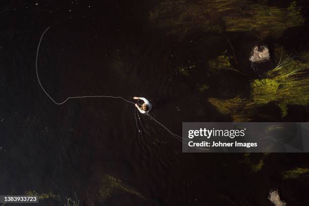 person fishing in river - river aerial stock pictures, royalty-free photos & images