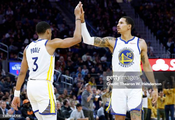 Jordan Poole of the Golden State Warriors is congratulated by Juan Toscano-Anderson after Poole made a three-point shot against the LA Clippers in...