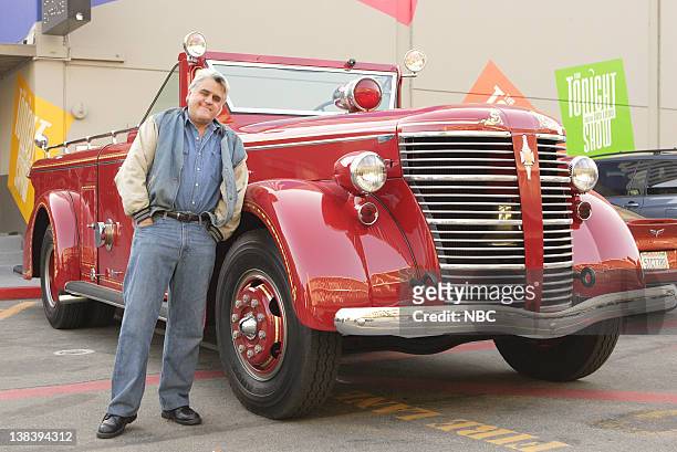 Episode 3348 -- Pictured: Host Jay Leno drives away in one of his many "automobiles," a vintage collector red fire engine, after the show on April...