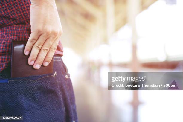 confident man posing in safe,midsection of woman with hands in pocket - woman hemorrhoids stock pictures, royalty-free photos & images