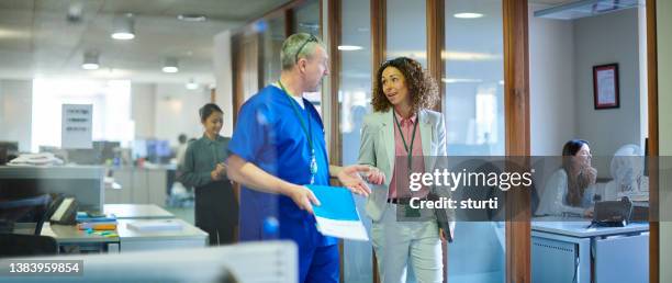 business meeting with medical practitioner - hospital manager stock pictures, royalty-free photos & images