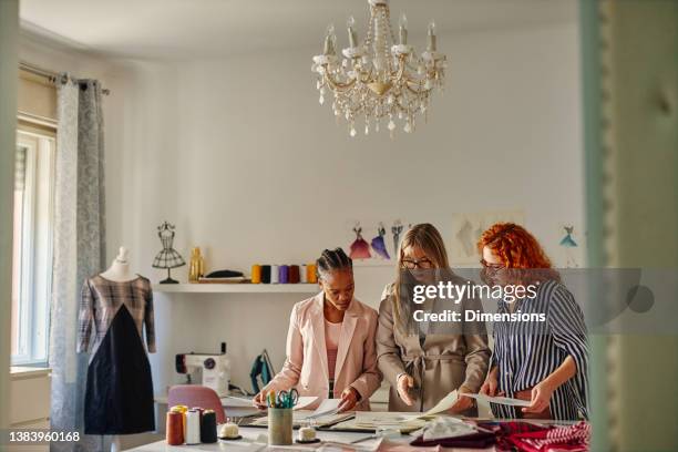 fashion designers on a meeting in studio - businesswear stock pictures, royalty-free photos & images