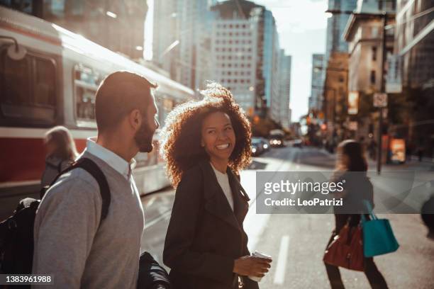 two colleagues walking to the office - downtown street stockfoto's en -beelden