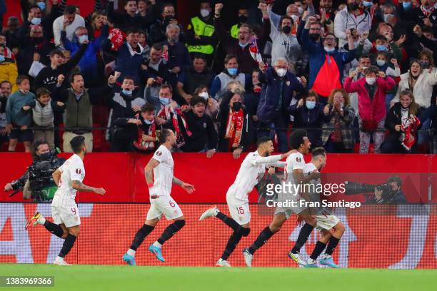 Munir El Haddadi of Sevilla FC celebrates with teammates after scoring their team's first goal during the UEFA Europa League Round of 16 Leg One...