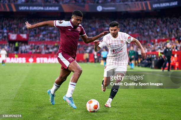 Jesus Manuel Tecatito Corona of Sevilla FC competes for the ball with Ben Johson of West Ham United during the UEFA Europa League Round of 16 Leg One...