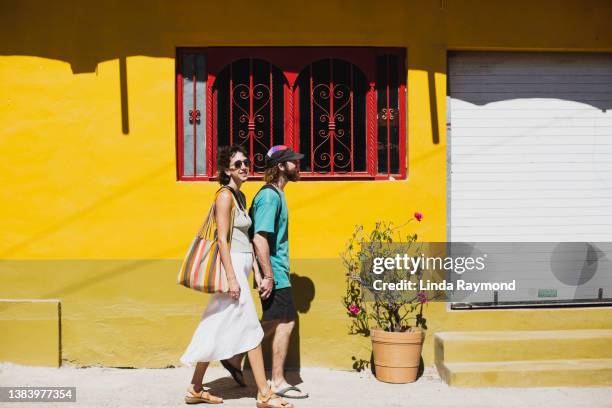 young couple walking in the street of  lo de marcos, nayarit, mexico - nayarit stock pictures, royalty-free photos & images