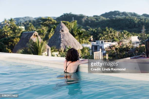 young woman in a swimming pool with a view - nayarit stock pictures, royalty-free photos & images