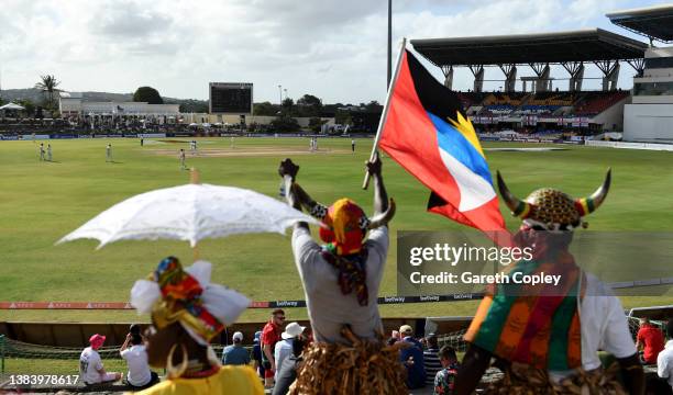 Antigua dancers dance with England fans during day three of the first test match between West Indies and England at Sir Vivian Richards Stadium on...