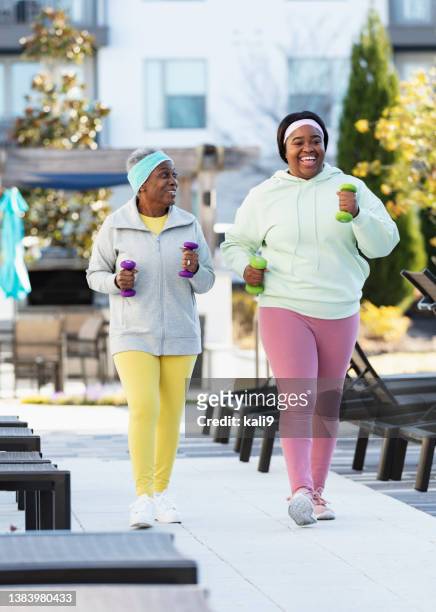 zwei afroamerikanische frauen powern im freien spazieren - family sports centre laughing stock-fotos und bilder