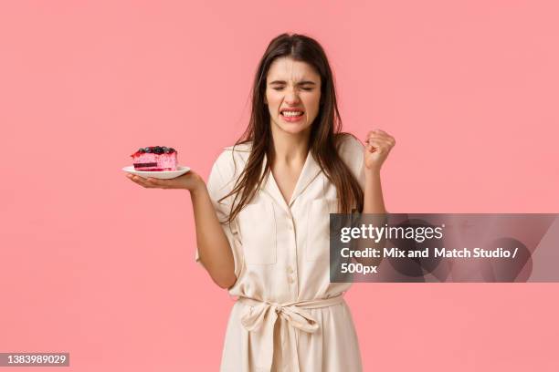 girl gonna puke from disgusting taste of cake disappointed young - puke // puke stock pictures, royalty-free photos & images