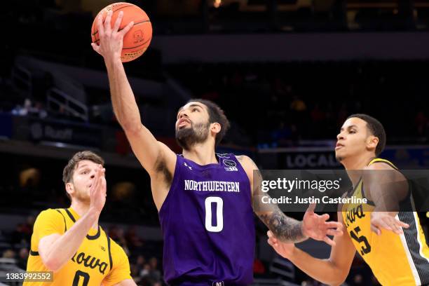 Boo Buie of the Northwestern Wildcats takes a shot during the second half in the game against the Iowa Hawkeyes during the Big Ten Tournament at...