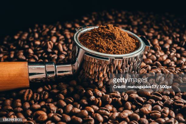close-up of coffee beans with roasted beans on table,prague,czech republic - ground coffee stock pictures, royalty-free photos & images