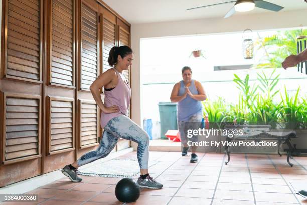 female friends exercising at home - hiit stock pictures, royalty-free photos & images