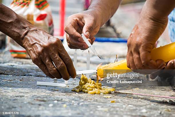 devotees lighting candles. - luisapuccini stock pictures, royalty-free photos & images