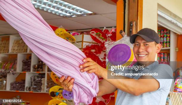 a happiness man making "melcochas" a traditional candy from baños, ecuador - boiled sweet stock pictures, royalty-free photos & images