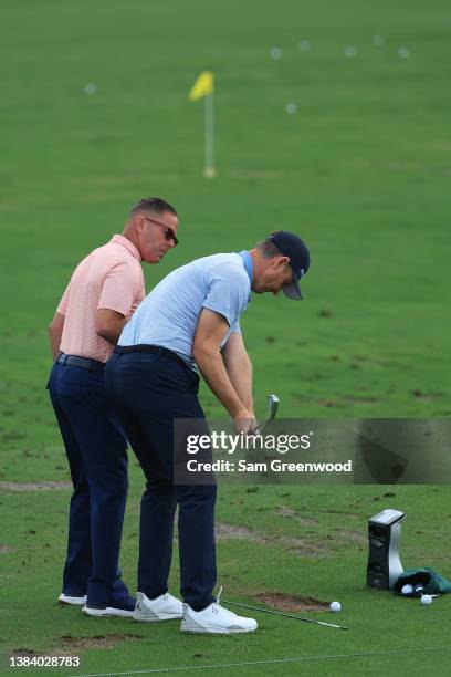 Justin Rose of England works with swing coach Sean Foley on the practice range during the first round of THE PLAYERS Championship on the Stadium...