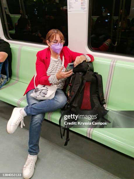 woman sitting in the public transport train - metro or subway with backpack - metro medellin stock pictures, royalty-free photos & images
