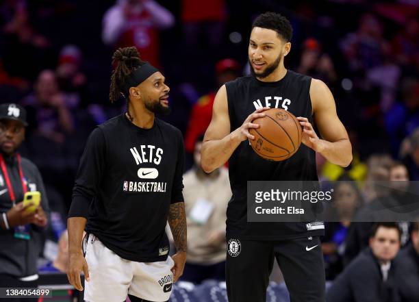 Patty Mills and Ben Simmons of the Brooklyn Nets take the court for warm ups before the game against the Philadelphia 76ers at Wells Fargo Center on...