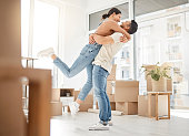 Shot of a young couple celebrating the move into their new home