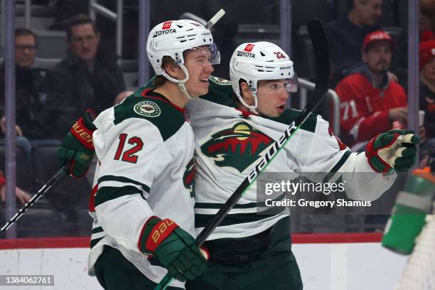 Matt Boldy of the Minnesota Wild celebrates his first period goal with Kevin Fiala while playing the Detroit Red Wings at Little Caesars Arena on...