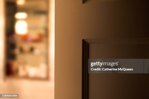 defocused view of open inset glass medicine cabinet in bathroom with door slightly ajar - child proof imagens e fotografias de stock