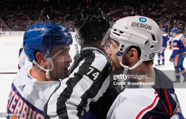 Cal Clutterbuck of the New York Islanders and Oliver Bjorkstrand of the Columbus Blue Jackets exchange words during the first period at the UBS Arena...