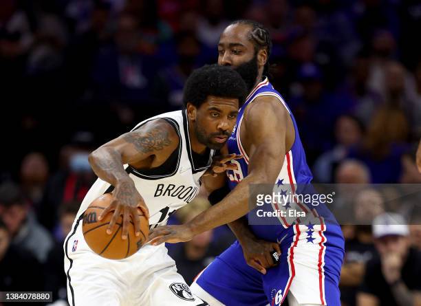 Kyrie Irving of the Brooklyn Nets tries to keep the ball from James Harden of the Philadelphia 76ers in the first half at Wells Fargo Center on March...