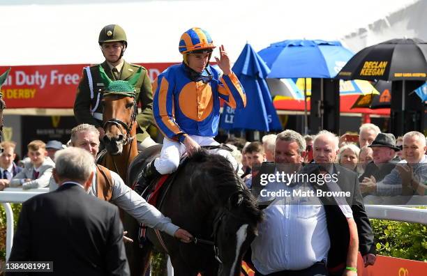 Kildare , Ireland - 2 July 2023; Jockey Ryan Moore is lead into the parade ring after winning the Dubai Duty Free Irish Derby on Auguste Rodin during...