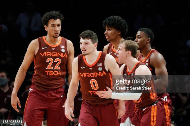 Keve Aluma, Hunter Cattoor, and Storm Murphy of the Virginia Tech Hokies react during the second half against the Notre Dame Fighting Irish in the...