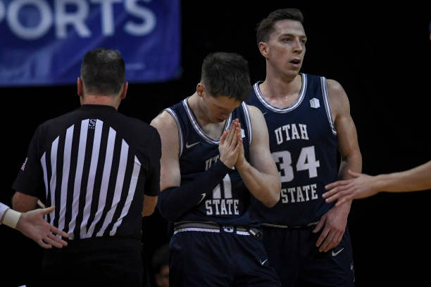 Max Shulga of the Utah State Aggies reacts to not getting an and-one attempt against the Colorado State Rams during the first half of the teams"u2019...